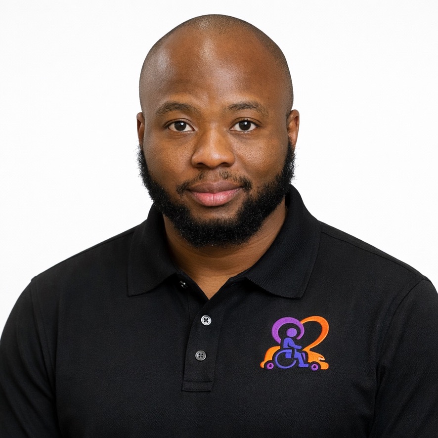 Carly Clement, Operations Manager at Inspiring Mobility & Care Rides wearing black polo with embroidered orange and purple logo