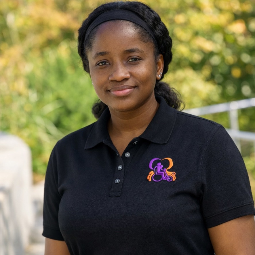 Doreen Edmond, CFO of Inspiring Mobility & Care Rides wearing black polo with embroidered orange and purple logo